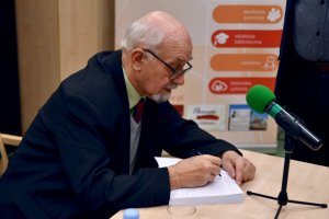 Na zdjęciu autor w czasie podpisywania książek.