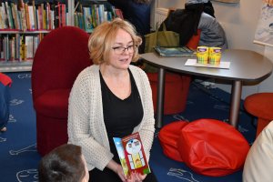Na zdjęciu powadzaca zajęcia bibliotekarka z dziećmi.